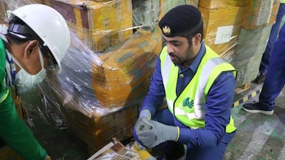 Dubai Customs officers uncover a shipment of fake mobile phones. The customs office often recycles counterfeit goods to protect consumers and limit environmental damage. Courtesy: Dubai Customs