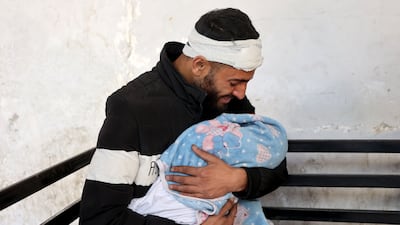 Palestinian Bilal Kallab holds the body of his 17-day-old baby, Adnan, who was killed during an Israeli air strike on Gaza city on Wednesday. AFP