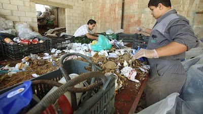 Two scavengers collect garbage at the Entity Green Training for recycling in Ein al-Basha near Amman, Jordan, October 10, 2009.