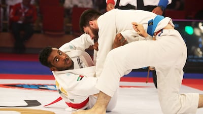 Mahdi Al Awlaqi from the UAE (red) beat Djabrailov Djabrail from France in the 77kg final in Abu Dhabi. Pawan Singh / The National