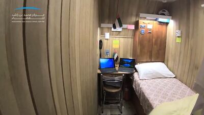 Mr Al Ameri's room in the complex. Each participant has a similar small space for privacy, while a small living room allows them to socialise and watch television. Each bedroom has a bed, desk and cupboard.