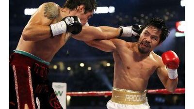 Manny Pacquiao, right, of the Philippines beat Antonia Margarito of Mexico during the World Super Welterweight title bout in Arlington, Texas. A reader hopes that the champion's next fight will be in Abu Dhabi. Mike Stone / Reuters