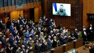 Ukrainian President Volodymyr Zelenskyy receives a standing ovation as he appears via videoconference to make an address to Canada's Parliament. AP