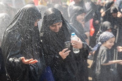 Cooling spray from a police water cannon at the funeral of former Iranian supreme leader Ayatollah Ali Khamenei. Getty Images