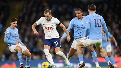Harry Kane of Tottenham Hotspur is challenged by Julian Alvarez and Manuel Akanji of Manchester City during their Premier League match at the Etihad Stadium on January 19, 2023. Getty