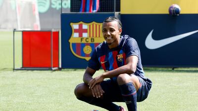 New Barcelona signing Jules Kounde with the club shirt and ball during his unveiling. Reuters