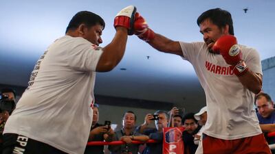 epa06879847 Filipino senator and boxing icon Manny Pacquiao (C) runs through some exercises at a gym in Kuala Lumpur, Malaysia, 11 July 2018. Manny Pacquiao and Lucas Matthysse have arrived in Malaysia ahead of the WBA welterweight championship fight, dubbed 'Fight of the Champions', which will take place in Kuala Lumpur on 15 July 2018. EPA/FAZRY ISMAIL
