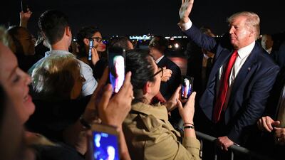 US President Donald Trump meets fans after stepping off Air Force One upon arrival at Miami International Airport in Miami, Florida. AFP