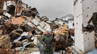 A local resident takes pictures of a destroyed monastery in Dolyna, eastern Ukraine. AFP