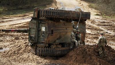 British soldiers recover an overturned armoured vehicle at an exercise in Bordon, Hampshire. Analysts say UK armed forces are in a critical state. AFP