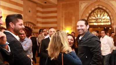 Lebanese Prime Minister Saad Hariri (R) greets supporters in his house in downtown Beirut while waiting for the electoral results. Anwar Amro / AFP