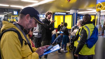 Travellers wait at the Central Station in Amsterdam as train traffic throughout the north of the Netherlands was halted due to a storm. EPA