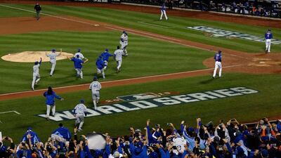 The Kansas City Royals dugout runs onto the field to celebrate with Wade Davis #17 after defeating the New York Mets in Game Five of the 2015 World Series at Citi Field on November 1, 2015 in the Flushing neighborhood of the Queens borough of New York City. The Kansas City Royals defeated the New York Mets with a score of 7 to 2. Doug Pensinger/Getty Images/AFP