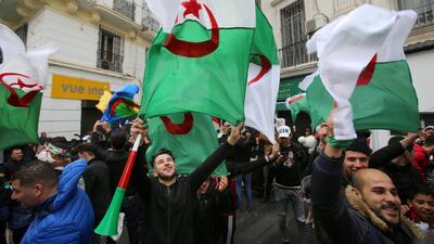 People wave Algerian national flags during a protest calling on President Abdelaziz Bouteflika to quit, in Algiers. Reuters
