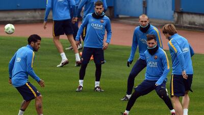 Ivan Rakitic, Lionel Messi and Dani Alves of Barcelona shown at training on Tuesday in Japan. Toshifumi Kitamura / AFP