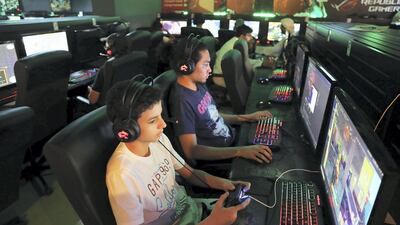 Children play video games at the Gee Gee Café in Abu Dhabi. Pawan Singh / The National
