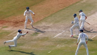 India's Virat Kohli dives to stop a ball during the third cricket test match between India and Australia, in Indore, in India. AP