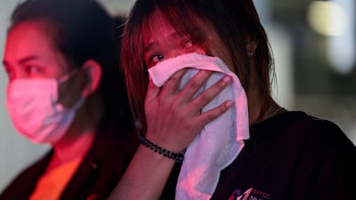 A woman overcome with grief after her sister died in the fire. Reuters