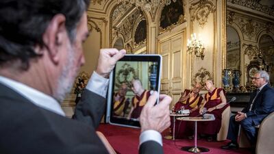The Dalai Lama (centre) sits next to French Buddhist monk Matthieu Ricard (left) and French senator Michel Raison (right) as he addresses a meeting with members of the parliamentary international group on Tibetan issues at the Salons de Boffrand at the French Senate premises in Paris. The Dalai Lama is on a six-day visit to France for the first time in five years. AFP