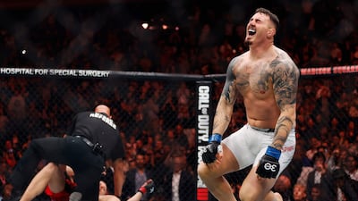 Tom Aspinall starts to celebrate after knocking out Sergei Pavlovich to win the interim UFC heavyweight championship title at UFC 295. Getty Images