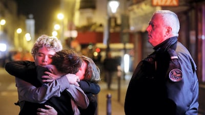 People hug on the street near the Bataclan concert hall following fatal attacks in Paris, France, in November 2015. Gunmen and bombers attacked busy restaurants, bars and a concert hall killing dozens of people. Reuters