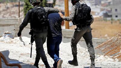 An Israeli border policeman grabs a Palestinian demonstrator during a protest against the Israeli demolitions of Palestinian homes in East Jerusalem. REUTERS