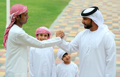 Abdul Hakim is on the road to recovery with help from Marzouq Al Hajerii, pictured with two of his children. Chris Whiteoak / The National
