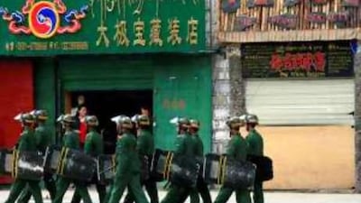Paramilitary policemen patrol a street in Lhasa in May.