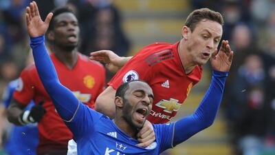 Leicester's Ricardo Pereira, left, falls as he challenge for the ball with Manchester United's Nemanja Matic. AP Photo