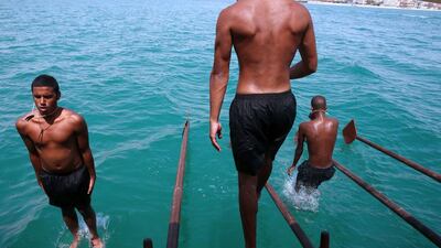 Kuwaiti divers search for mollusk shells containing pearls during the annual pearl diving season off the coast of the port city of Khairan, south of Kuwait City. Yasser Al-Zayyat / AFP