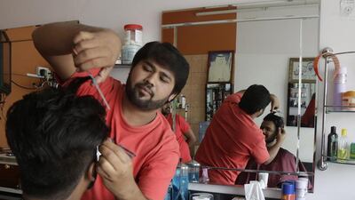 Aqeel Ahmad gets an Eid customer looking ship shape at Khosa Bossa Gents Saloon. Jeffrey E Biteng / The National