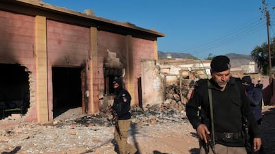 Policemen guard a Hindu temple after it was set on fire and demolished by a mob led by Islamists in north-eastern Pakistan on December 31, 2020. AP Photo