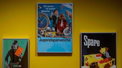 Advertising posters for consumer saving aimed specifically at children in West Germany (from L) from 1955, 1967 and 1951 are on display at the exhibition "Saving - History of a German Virtue" at the German History Museum in Berlin. John Macdougall / AFP