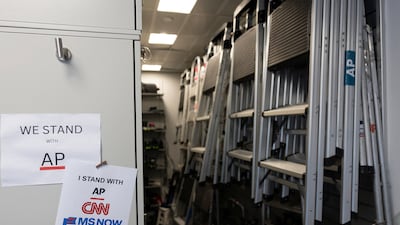 Signs hang in the media work area at the White House after CNN, MS NOW, and Politico were kicked off the White House grounds. Reuters