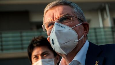 Thomas Bach, International Olympic Committee (IOC) president wearing a protective mask, talks to journalists during a visit to Olympic and Paralympic village in Tokyo, Japan. Reuters