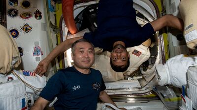 Astronaut Koichi Wakata and Sultan Al Neyadi inside the International Space Station's Quest airlock. Nasa