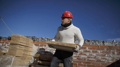 A worker carries tiles at a construction site of a residential block in the Valdebebas neighbourhood. In Madrid, the city council issued 3,131 building permits for residential use in the first 10 months of 2014, more than it awarded in the whole of 2013. Andrea Comas / Reuters