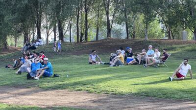 Spectators watch from an embankment overlooking the pitch