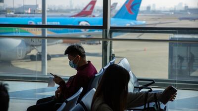 Travellers sit at a boarding gate at the Shanghai Hongqiao International Airport. Only a third of passengers have taken a commercial flight since the pandemic began, a figure that rises to almost half for UAE fliers, according to Inmarsat's Passenger Confidence Tracker. Associated Press
