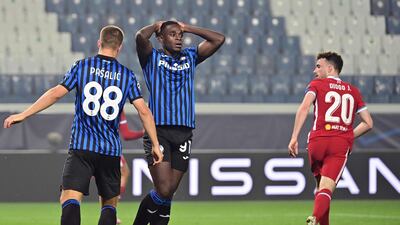 Atalanta's Colombian forward Duvan Zapata reacts next to Liverpool's Portuguese striker Diogo Jota. AFP