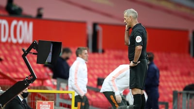 Referee Martin Atkinson checks the VAR display screen before awarding Crystal Palace a penalty. Getty