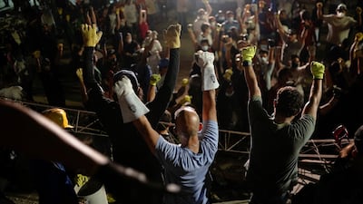 Rescuers call for silence to locate victims trapped under the rubble. Reuters