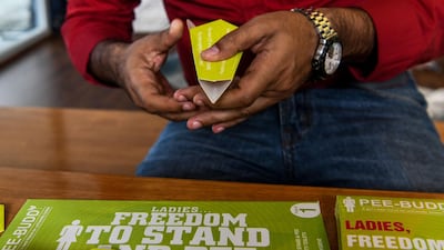 Founder of 'Pee Buddy' Deep Bajaj shows a portable female urination device inside the company's office in New Delhi. AFP