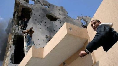 Rebels escape a building they had thought to be empty in Misurata. Inside they had found gunmen they loyal to Col Muammar Qaddafi.