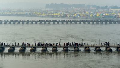 Hindus cross pontoon bridges spanning the Sangam, the confluence of the Ganges, Yamuna and Saraswati rivers, to take a holy dip to mark Mauni Amavasya, the most auspicious day, during the Magh Mela Festival in Prayagraj, India, on January 21. Reuters