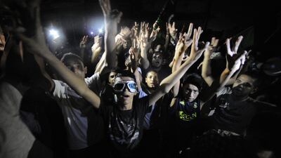 Supporters of Libya's rebels shout slogans in support of the opposition against Libyan leader Moamer Kadhafi in the capital Tripoli late on August 22, 2011 as rebels said they had sent more fighters and weaponry by sea to the capital from their coastal en???