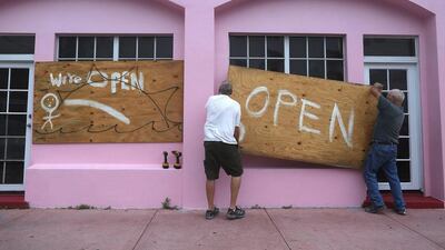 Miami Beach residents put up plywood on a window as they prepare for Hurricane Matthew on October 6, 2016. Joe Raedle/Getty Images/AFP