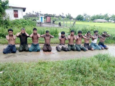 Ten Rohingya Muslim men with their hands bound kneel in Inn Din village on September 1, 2017. Reuters