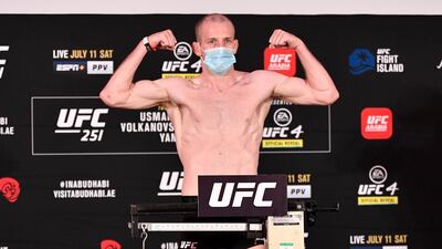 Danny Henry of Scotland poses on the scale during the UFC 251 official weigh-in.