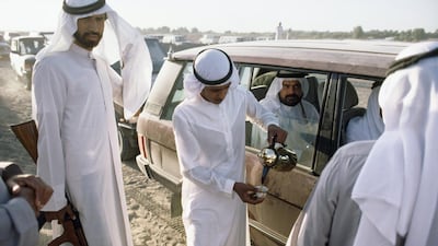 Body guards pour coffee for a sheikh at a camel race, Adh Dhayd, Sharjah, United Arab Emirates Steven L. Raymer / National Geographic / Getty Images
